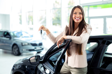 Salesperson selling cars at car dealership
