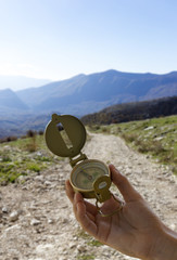 compass in hand and mountain background