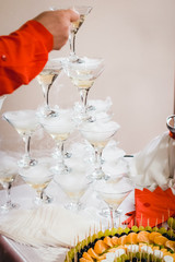 Champagne glasses standing in a tower at the party