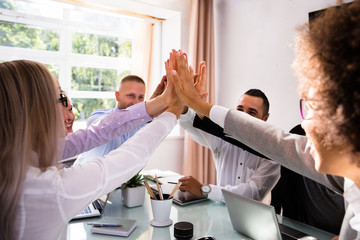 Group Of Businesspeople Giving High Five