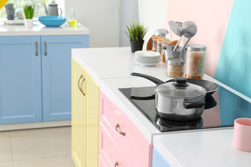 Electric stove with pan in kitchen