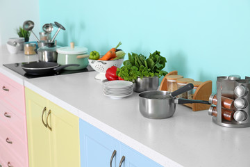 Naklejka na ściany i meble Cookware on table in modern kitchen