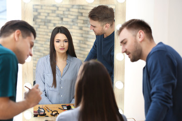 Professional makeup artist teaching trainee in salon. Apprenticeship concept