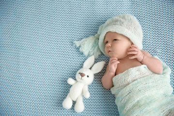 Cute newborn baby girl lying on plaid