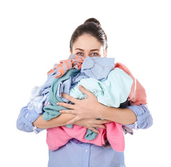 Woman holding pile of dirty laundry on white background