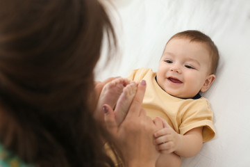 Loving mother playing with her baby at home