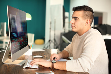Young man working with computer in office