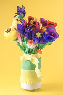 Origami flowers. Paper flowers. Handmade flowers on a yellow background