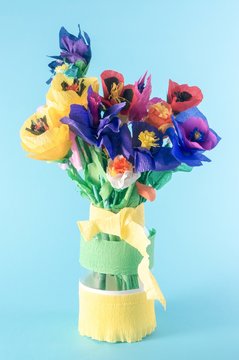 Colorful origami flowers / paper flowers / bunch of flowers on a blue background