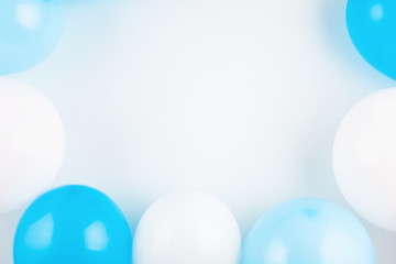 Top view shot with blue and white balloons. Celebration and greetings concept