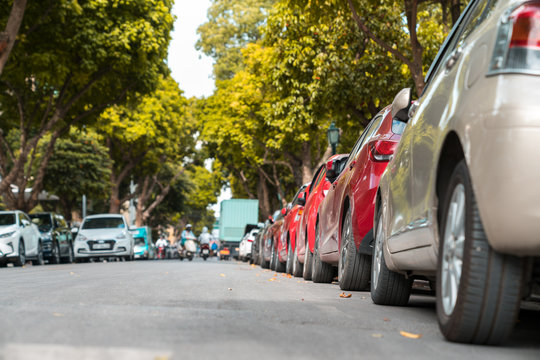 Parallel parking cars on urban street. Outdoor parking on road