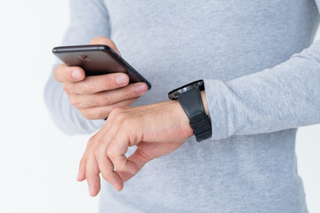 smart watch and wearable technology. man checking new notification on his phone