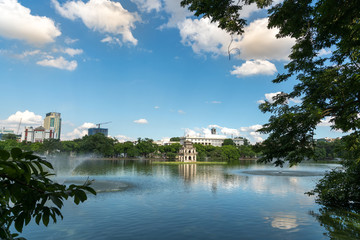 Fototapeta premium Hoan Kiem lake or Sword lake, Ho Guom in Hanoi, Vietnam with Turtle Tower, on clear day with blue sky and white clouds