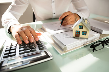 Businessman's hand calculating invoice