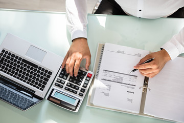 Businessman calculating bill