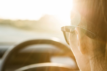 Female tourist or woman driver inside the car. Tourism or road trip or adventure.