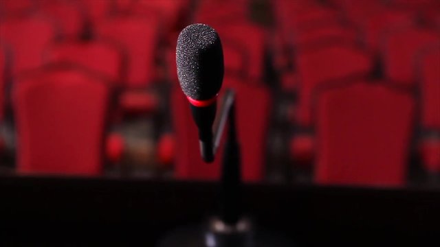 Close up of microphone in conference hall. Scene. Microphone on stage close-up in an empty room