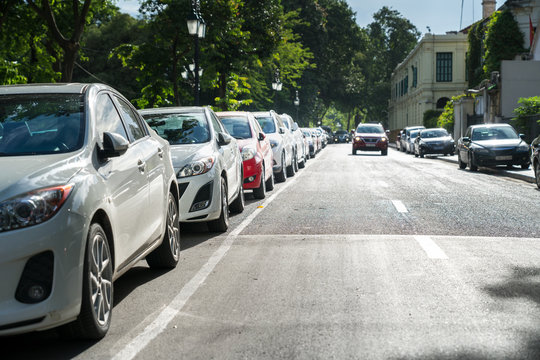 Parallel parking cars on urban street. Outdoor parking on road
