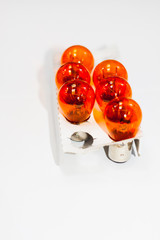 Orange light bulb for car on white background 