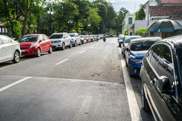 Parallel parking cars on urban street. Outdoor parking on road