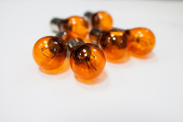 Orange light bulb for car on white background 