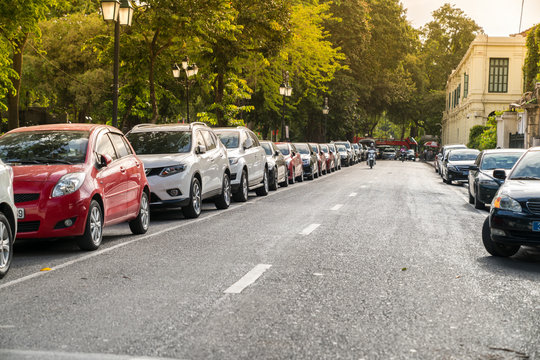 Parallel parking cars on urban street. Outdoor parking on road
