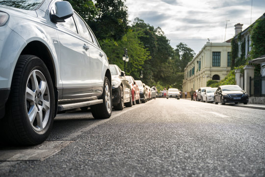 Parallel parking cars on urban street. Outdoor parking on road