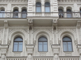 Fototapeta na wymiar Fragment of the facade of the building with elements of an architectural decor, eclecticism, St. Petersburg 