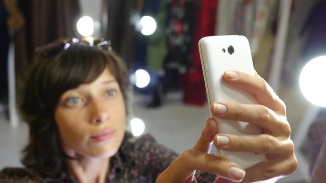 Cute young brunette woman take photo selfie via white smart phone