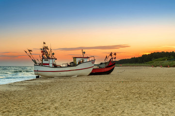 Naklejka na ściany i meble Fishing boat parked on the beach