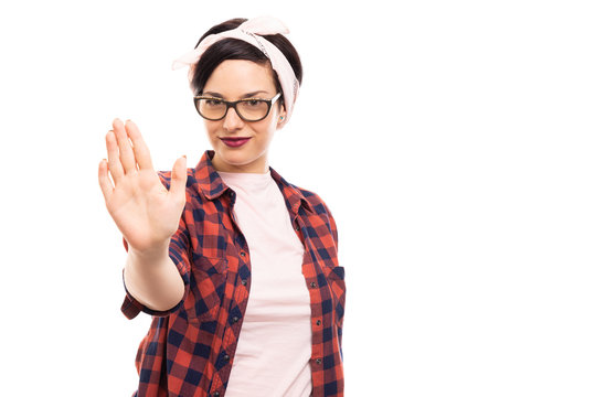 Pretty pin-up girl wearing glasses showing stop gesture with hand.