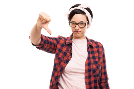 Pretty pin-up girl wearing glasses showing thumb down gesture.