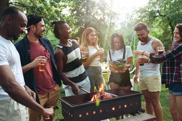 Group of friends making barbecue in the backyard. concept about good and positive mood with friends