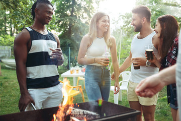 Group of friends making barbecue in the backyard. concept about good and positive mood with friends