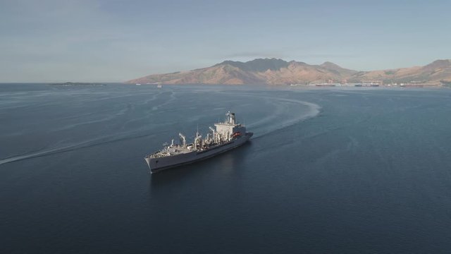 Aerial view: Cargo, Reefer ship in the sea bay. Subic Bay, Philippines, Luzon. Cargo ship in the harbor, against the backdrop of the mountains.
