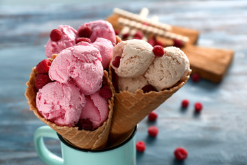 Waffle cones with tasty raspberry ice-cream in cup