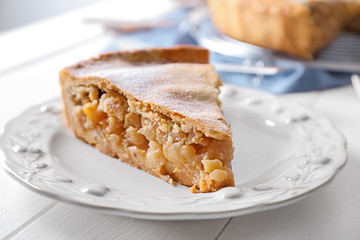 Piece of tasty apple pie on plate, closeup