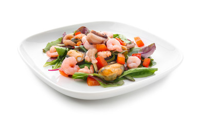 Plate of delicious vegetable salad with seafood on white background