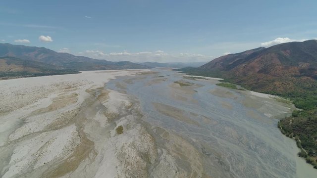 Parched river in mountain province Luzon, Philippines. Aerial view Drought in mountain valley, dry and shallow Bucao river.