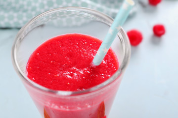 Glass of tasty raspberry smoothie, closeup