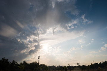 Trees and Houses Under Dramatic Sky