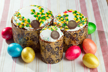 Russian Easter bread kulich paska decorated with painted colorful Easter eggs