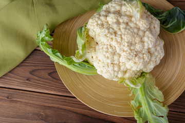 Organic cauliflower on wooden background