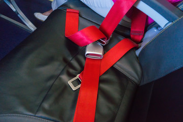 Red seat belt on the seat in the airplane