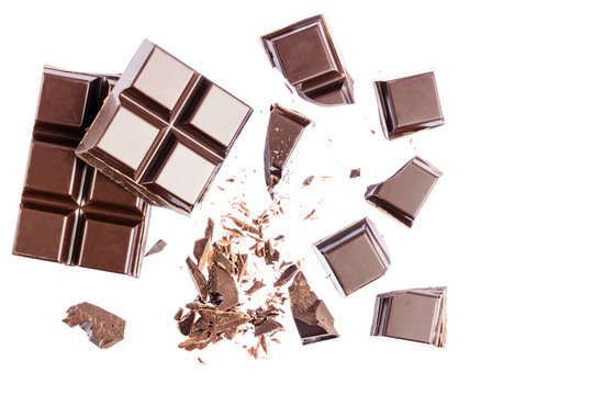 Chocolate cubes, pieces of bitter, dark chocolate, isolated on white background, top view