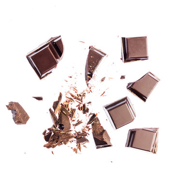 Chocolate cubes, pieces of bitter, dark chocolate, isolated on white background, top view