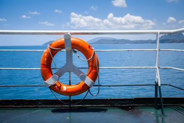 Life buoy hanging on a flat top of a ferry roof.