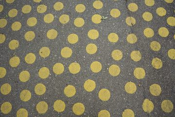 grey concrete with yellow dots