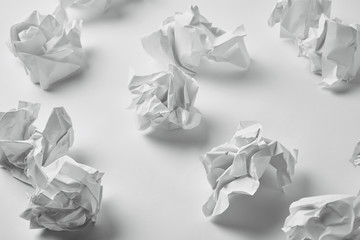 close-up shot of messy crumpled papers on white surface
