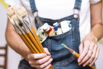 girl painter holds a brush